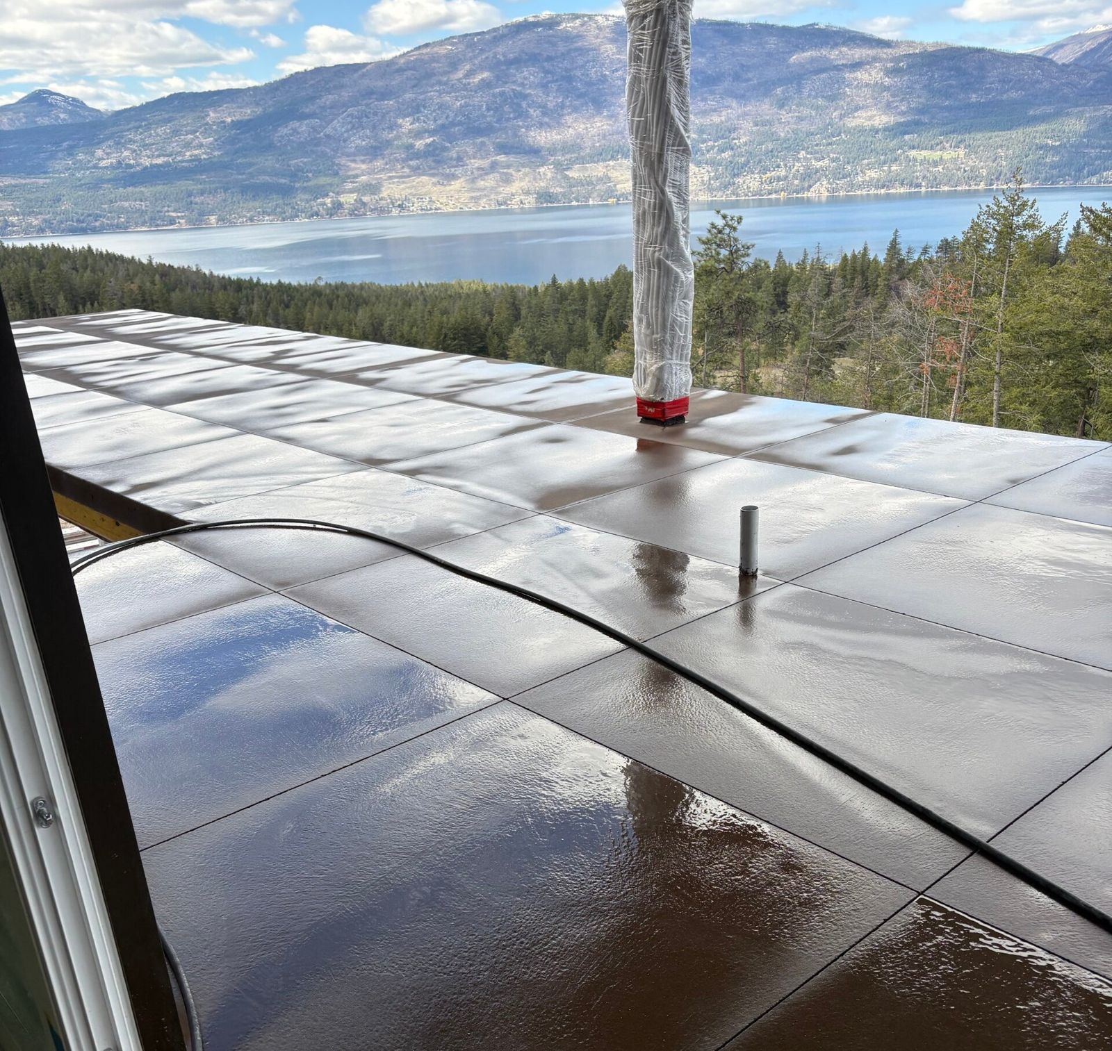 Freshly sealed concrete deck overlooking Okanagan Lake